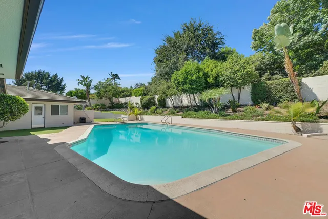 a view of a swimming pool with a patio