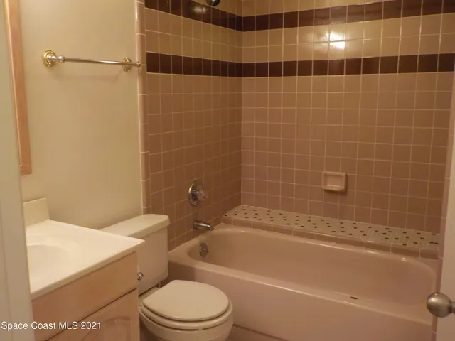 a bathroom with a toilet a sink and bathtub