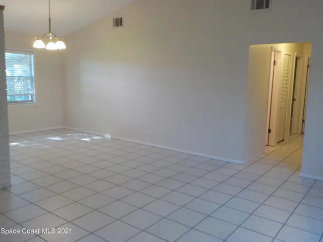 an empty room with windows and entrance