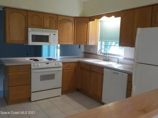 a kitchen with a sink stove and refrigerator