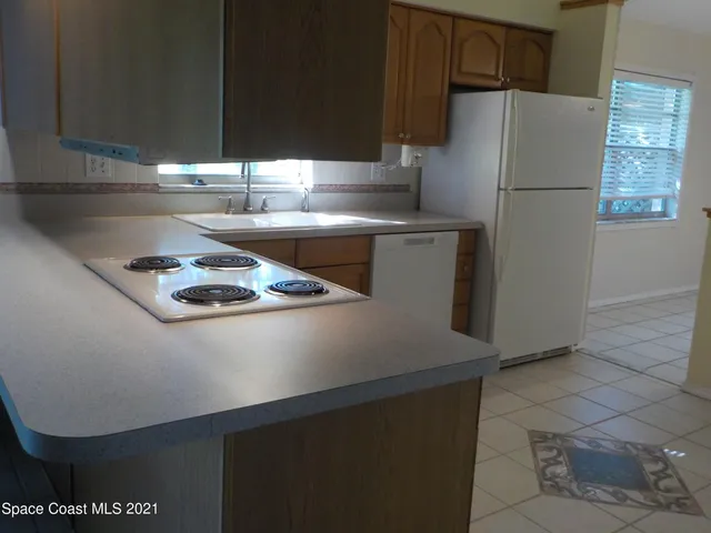 a kitchen with a refrigerator and a sink