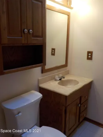 a bathroom with a sink a toilet and mirror