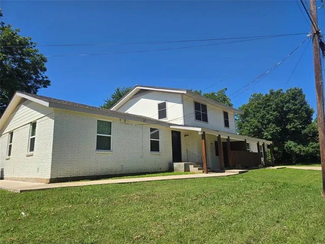 a front view of a house with a yard