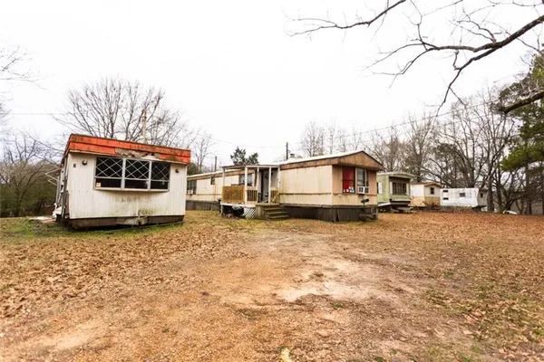 a white house that has a tree in front of it