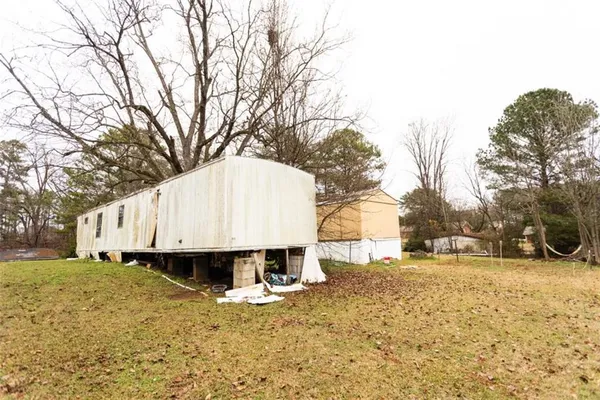a front view of a house with a yard and lake view