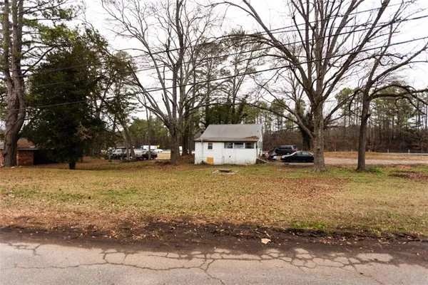 a view of a house with a yard covered in snow