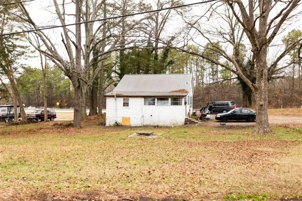 a view of a yard with a large tree