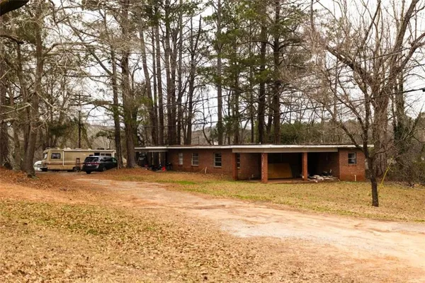 a house view with a car park in front of it