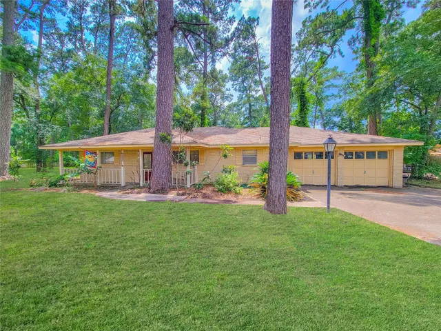 a view of a house with backyard and a sitting area