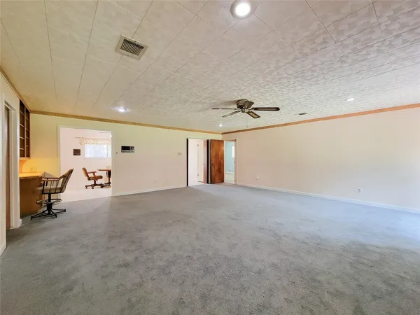 a view of empty room with a fireplace and window