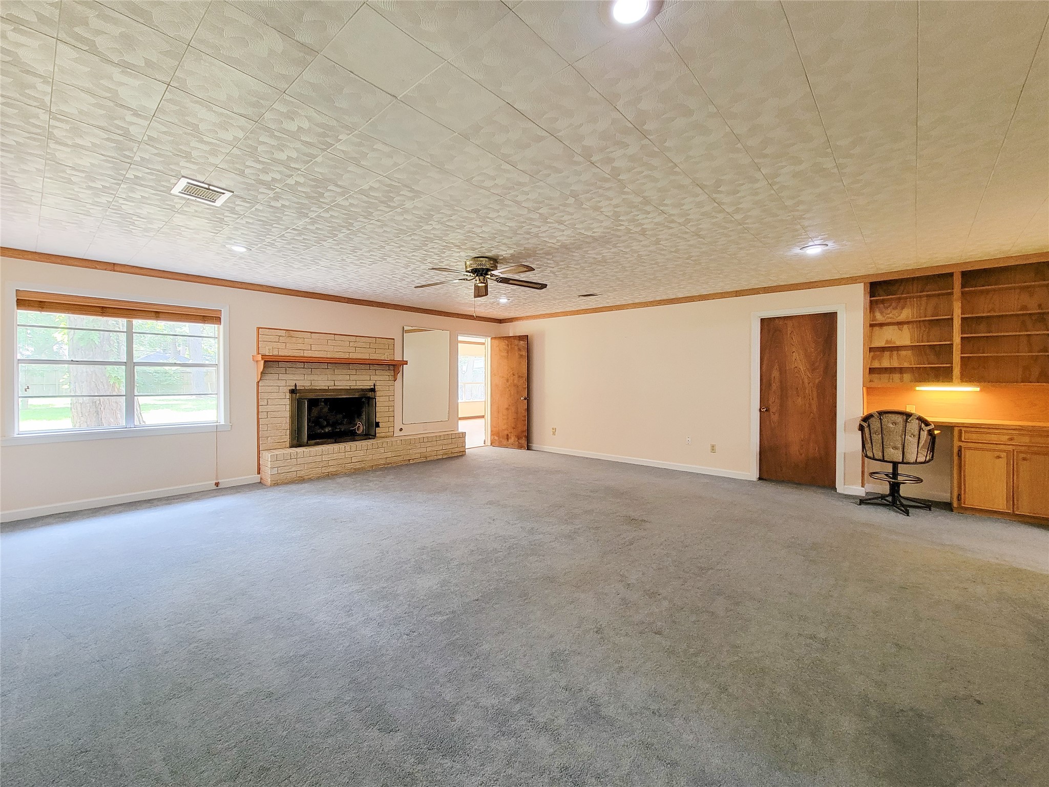 12119 Beverly Drive Houston, TX 77065 - Photo 12 of 32 a view of empty room with a fireplace and window
