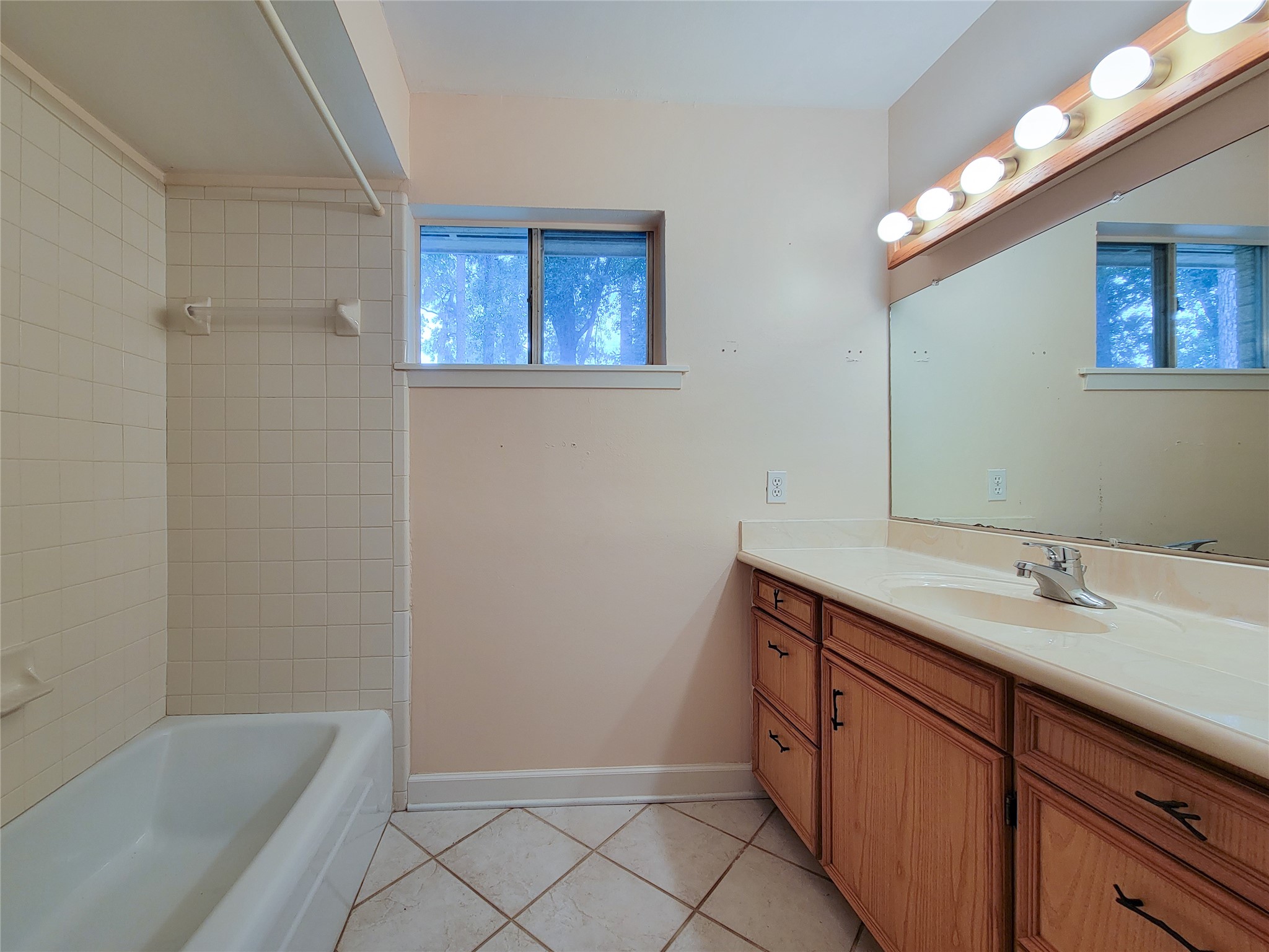 12119 Beverly Drive Houston, TX 77065 - Photo 22 of 32 a bathroom with a sink a vanity and a mirror