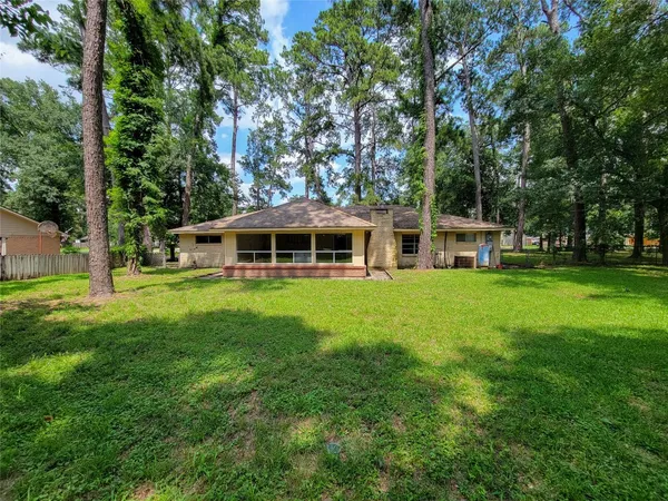 a view of a house with a yard and sitting area
