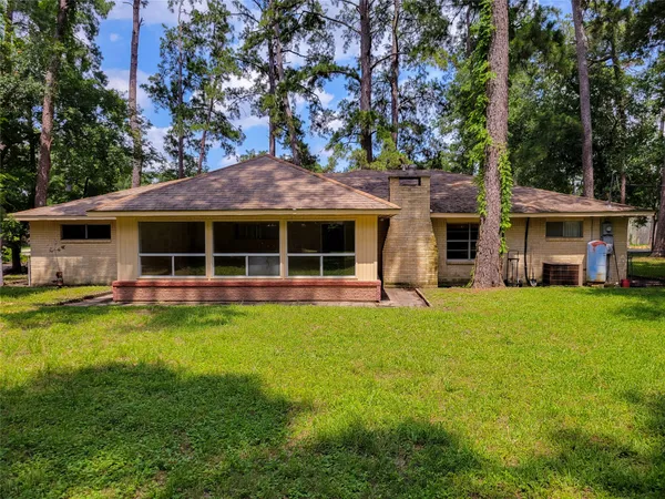 a view of a house with a yard and sitting area