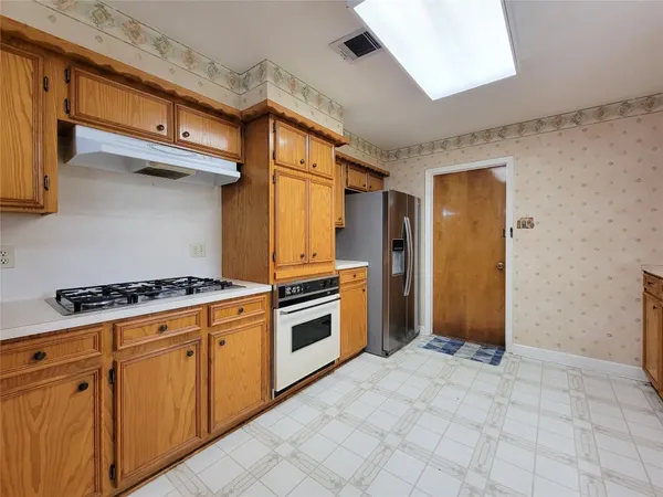 a kitchen with stainless steel appliances granite countertop a sink and cabinets