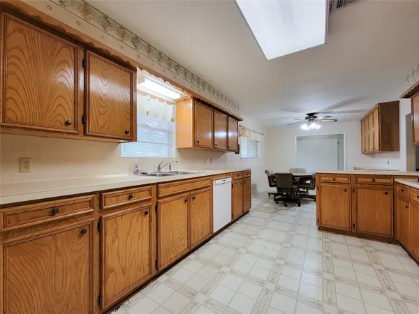 a kitchen with cabinets a sink and appliances