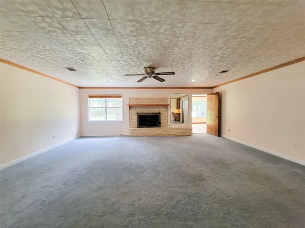 a view of empty room with a fireplace
