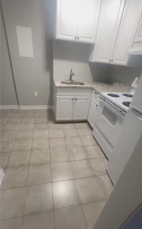 a kitchen with a sink a stove and cabinets
