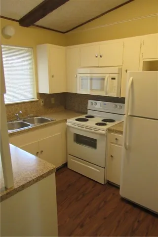 a view of a kitchen with wooden floor