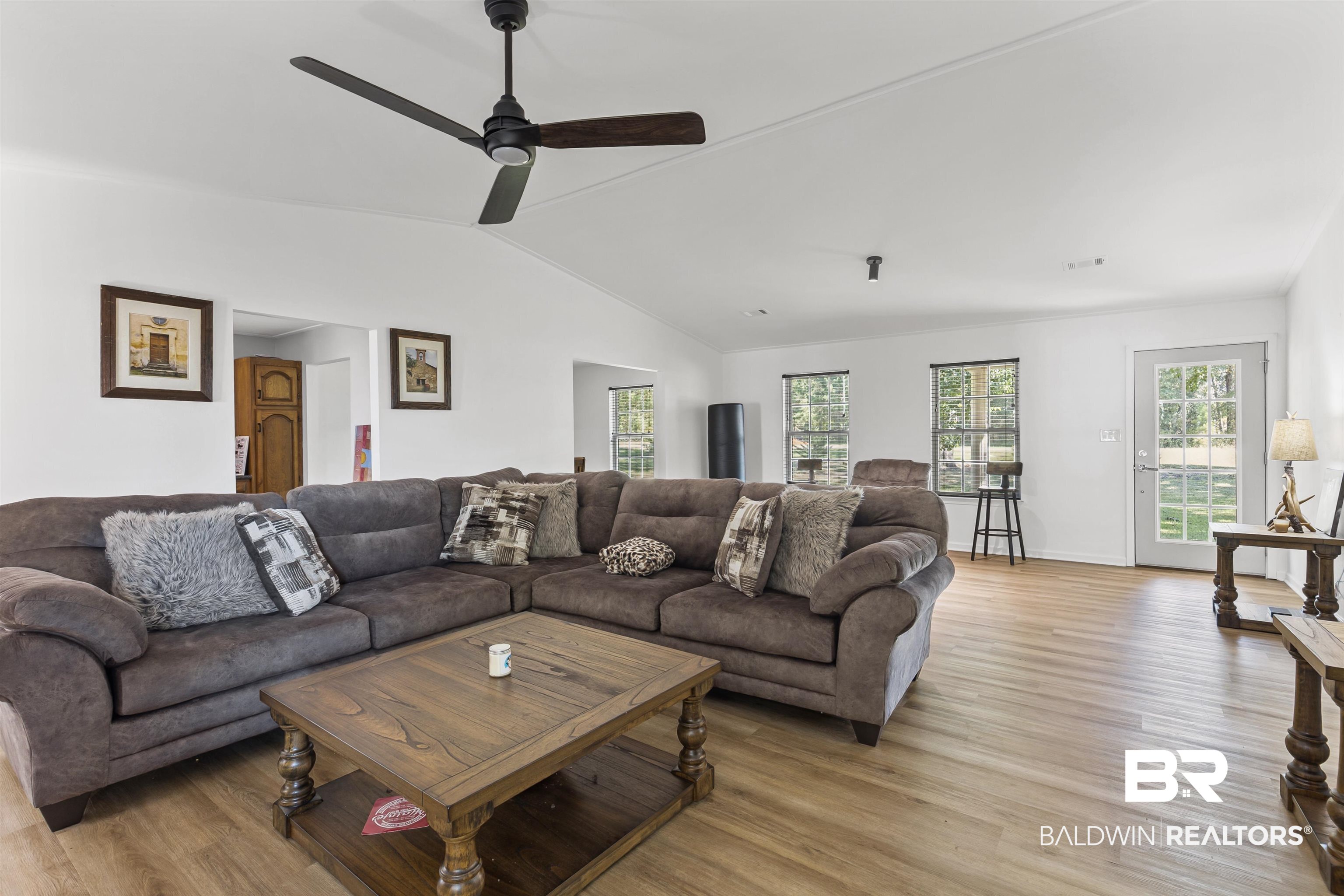 8911 Owassa Road Evergreen, AL 36401 - Photo 8 of 24 Living room featuring light wood-style floors, vaulted ceiling, and ceiling fan