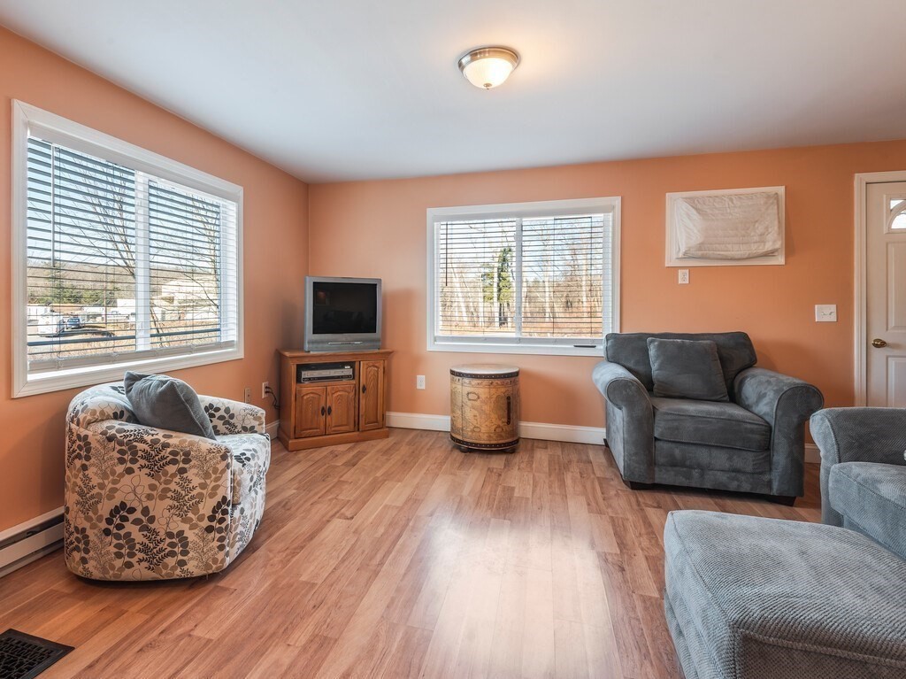 75 Lawrence Street Northborough, MA 01532 - Photo 13 of 38 a living room with furniture and a flat screen tv