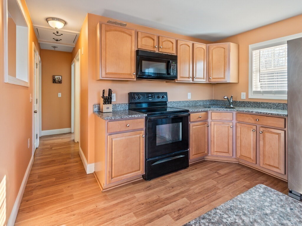 75 Lawrence Street Northborough, MA 01532 - Photo 19 of 38 a kitchen with stainless steel appliances granite countertop a stove a sink and a microwave