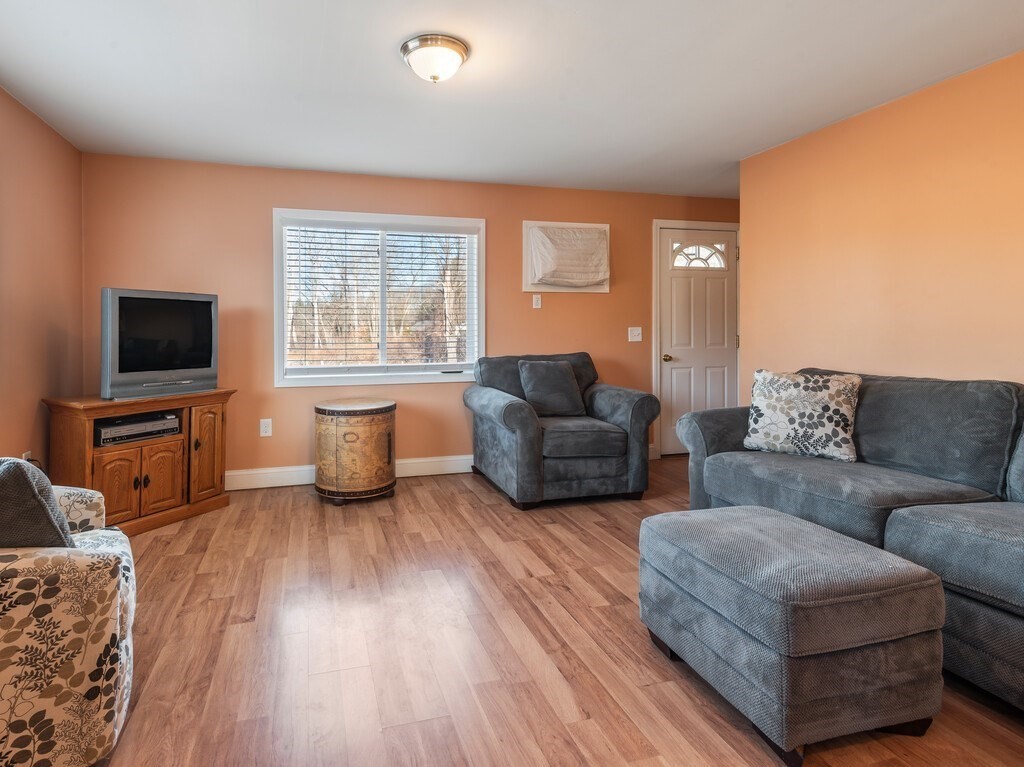 75 Lawrence Street Northborough, MA 01532 - Photo 22 of 38 a living room with furniture and a flat screen tv