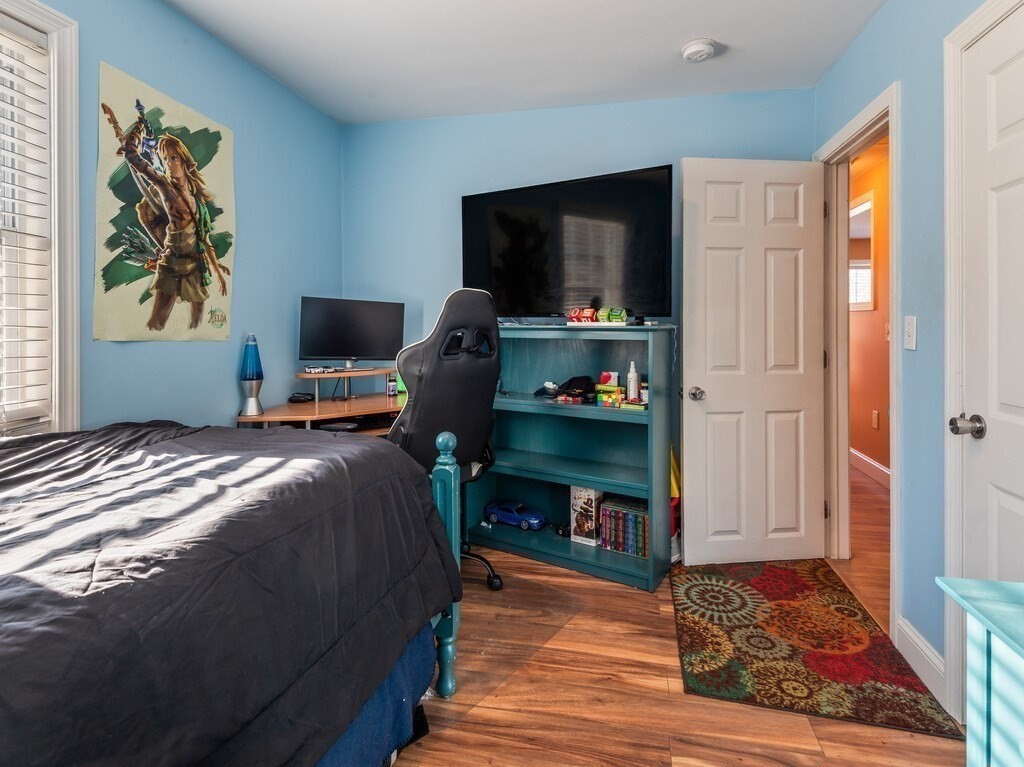 75 Lawrence Street Northborough, MA 01532 - Photo 25 of 38 a bedroom with a bed and a flat screen tv