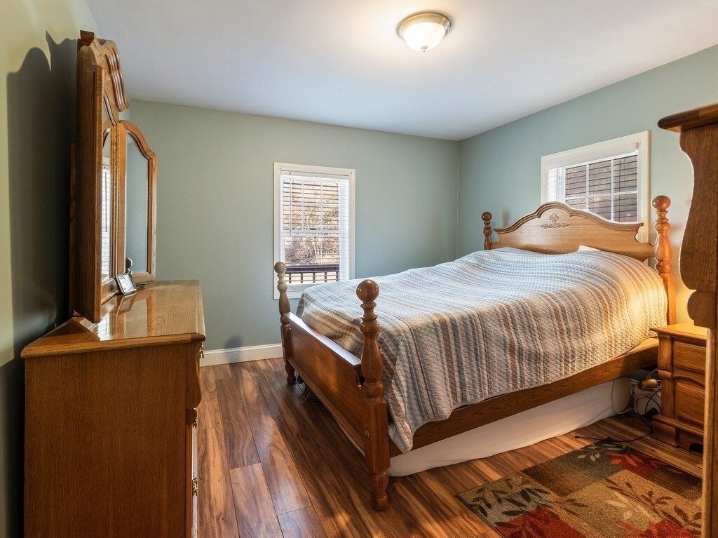 75 Lawrence Street Northborough, MA 01532 - Photo 27 of 38 a bedroom with a bed and wooden floor