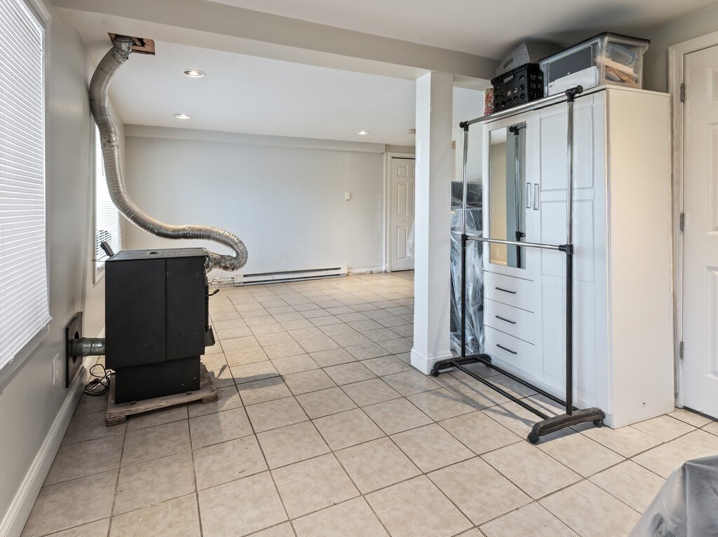75 Lawrence Street Northborough, MA 01532 - Photo 30 of 38 a view of a refrigerator in kitchen and an empty room