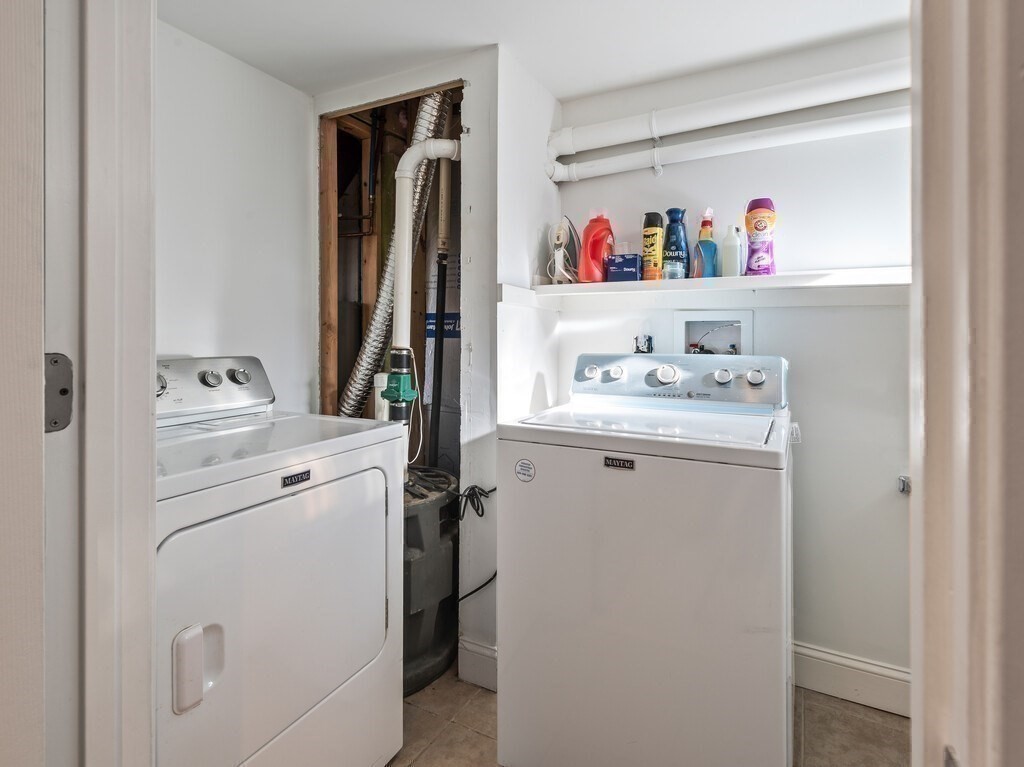 75 Lawrence Street Northborough, MA 01532 - Photo 35 of 38 a storage room with washer and dryer