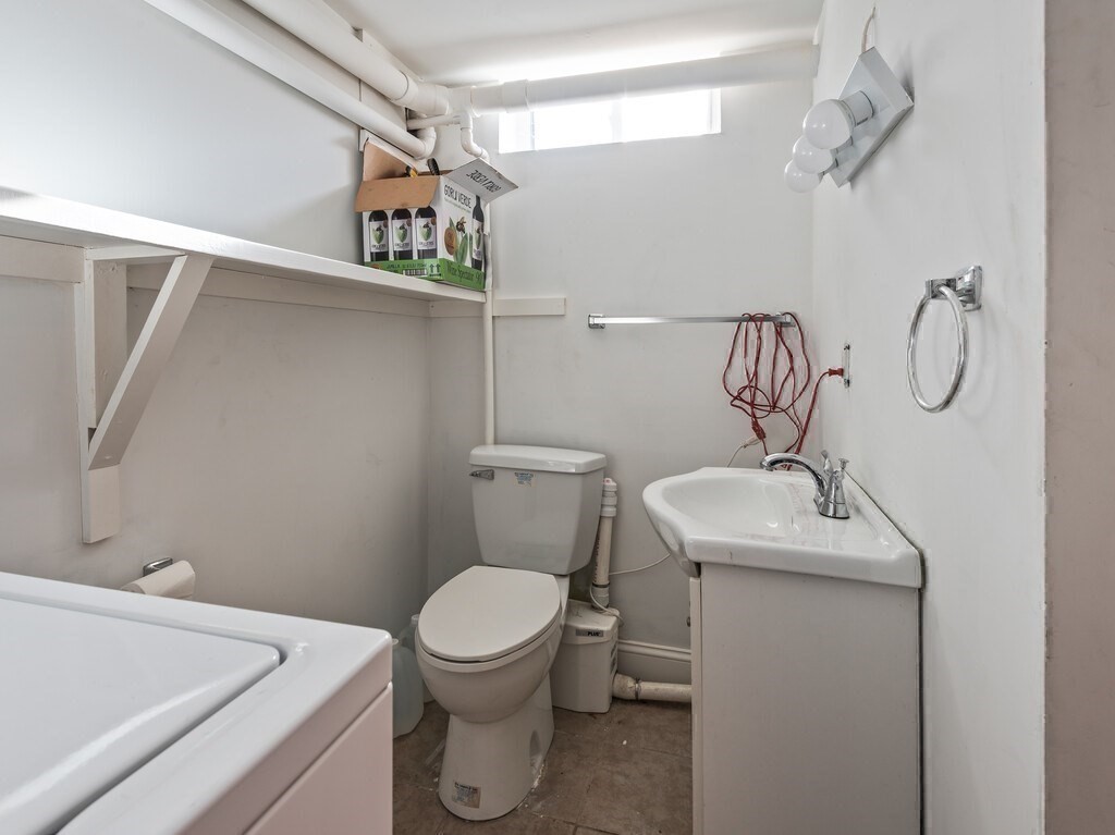 75 Lawrence Street Northborough, MA 01532 - Photo 37 of 38 a bathroom with a toilet sink and mirror