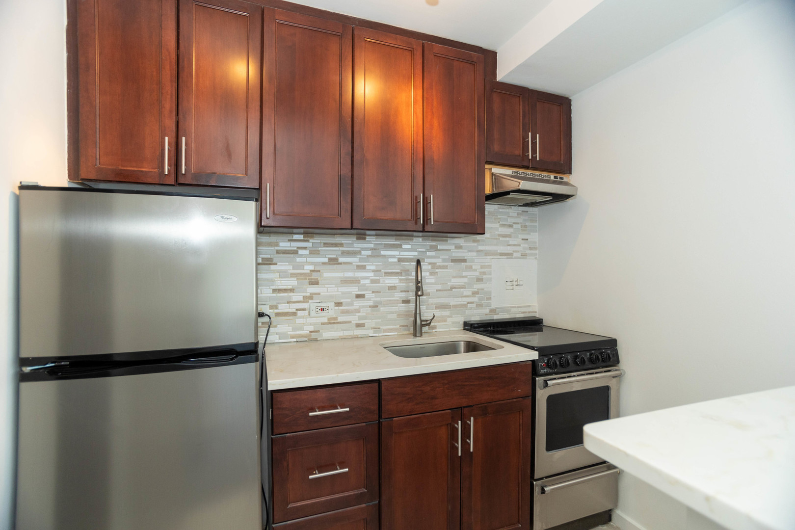 2909 North Sheridan Road, Unit 1701 Chicago, IL 60657 - Photo 12 of 16 a kitchen with a refrigerator sink and cabinets