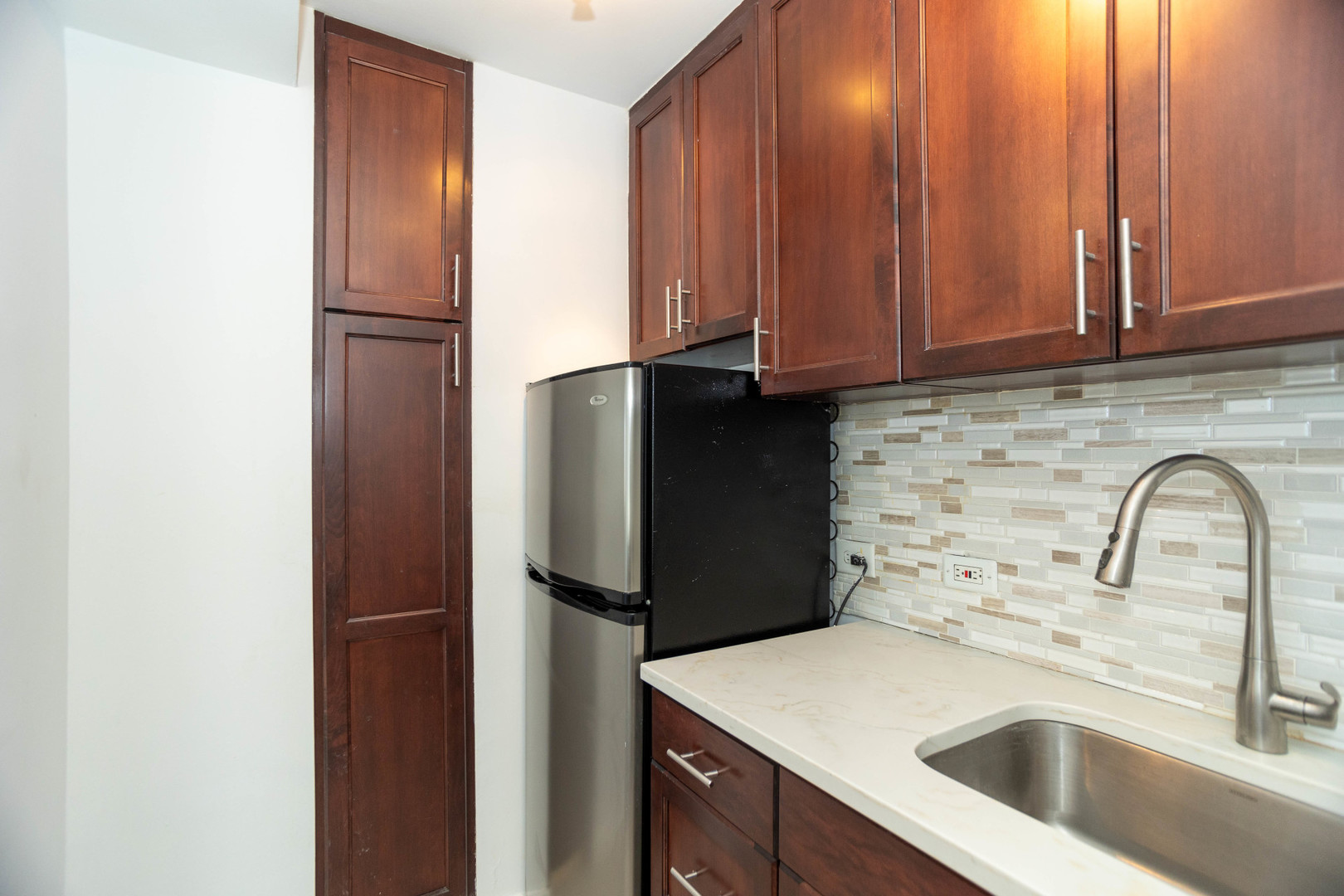 2909 North Sheridan Road, Unit 1701 Chicago, IL 60657 - Photo 13 of 16 a kitchen with a refrigerator and a sink