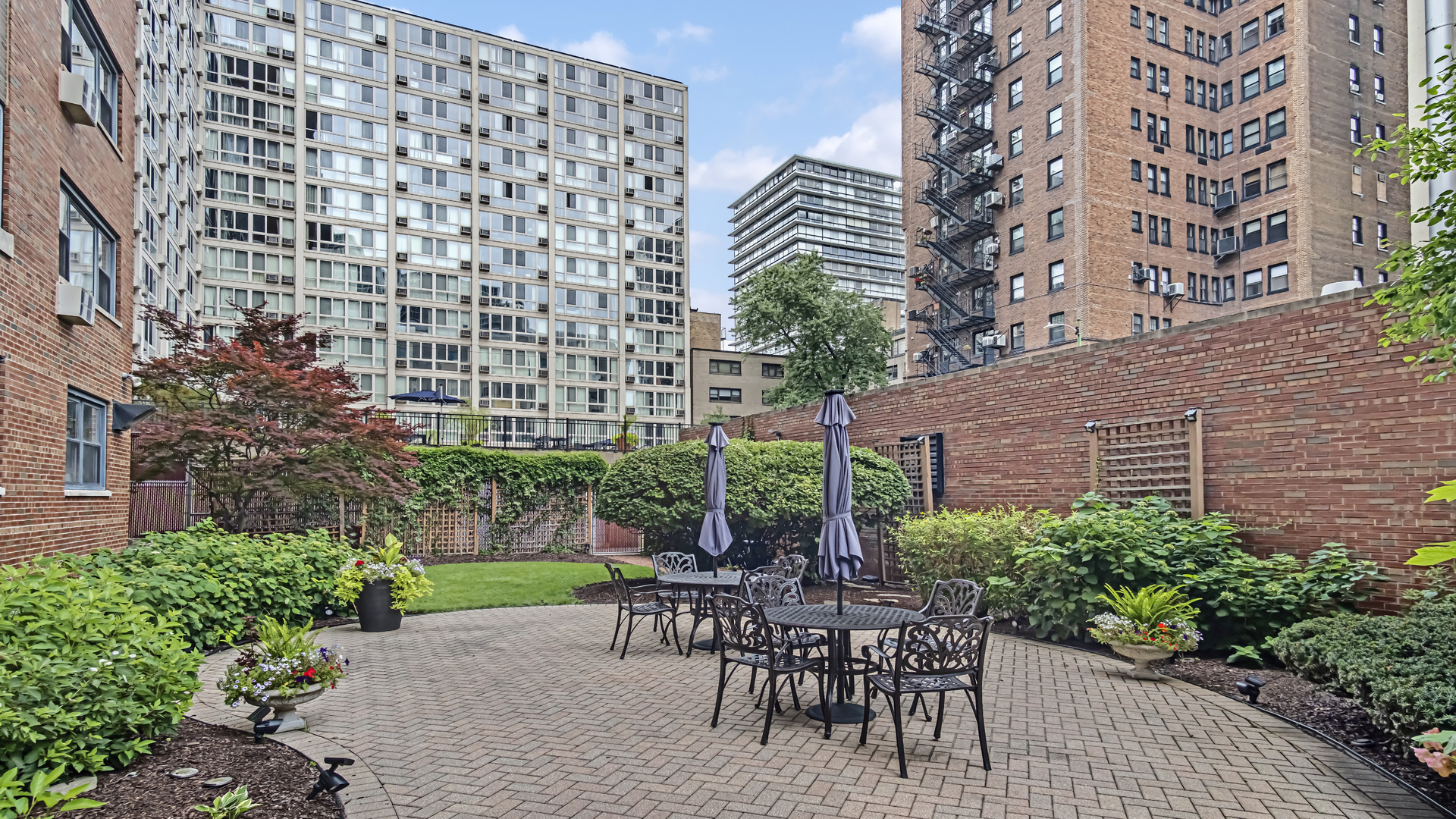 2909 North Sheridan Road, Unit 1701 Chicago, IL 60657 - Photo 3 of 16 a view of a patio with table and chairs and potted plants