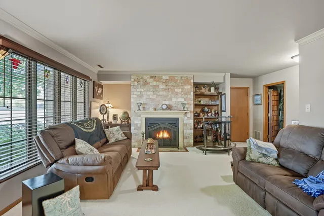 a living room with furniture large window and a fireplace