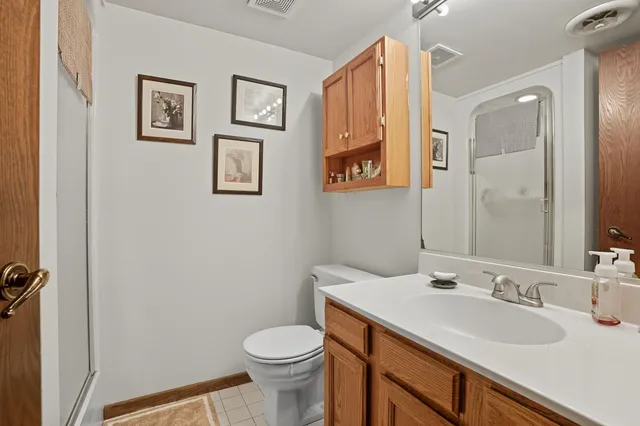a bathroom with a sink mirror vanity and toilet