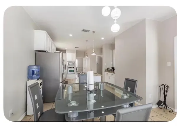 a view of kitchen and dining area with chandelier