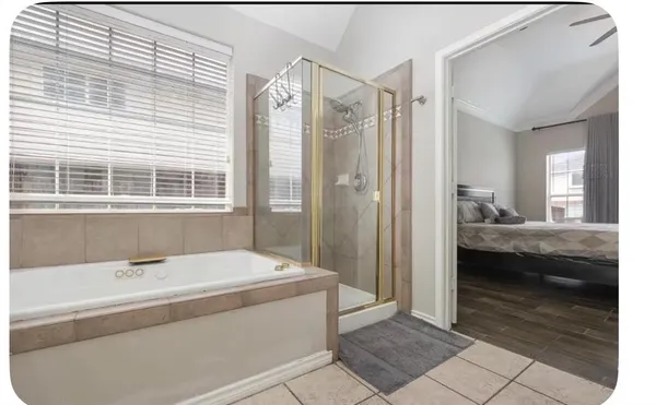 a en suite bathroom with a tub shower and sink