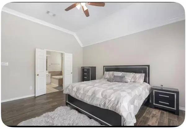 a bedroom with a bed and dresser