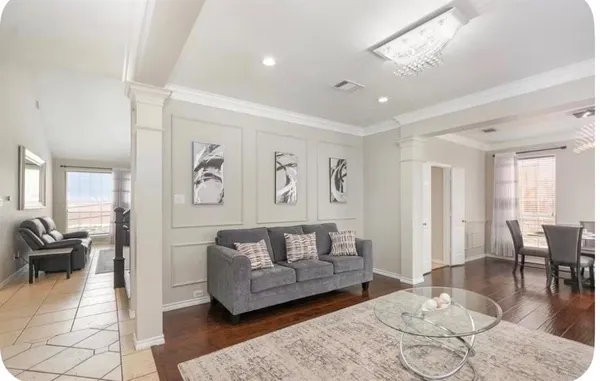 a living room with furniture and wooden floor