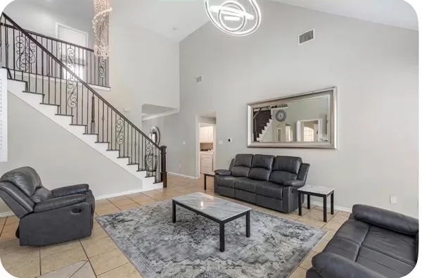 a living room with furniture and a rug