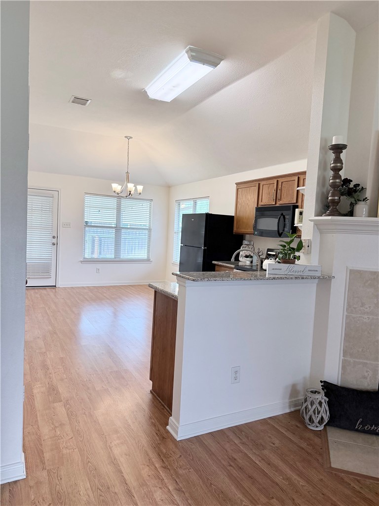 1029 Fallbrook Loop College Station, TX 77845 - Photo 7 of 34 a view of kitchen with microwave and wooden floor