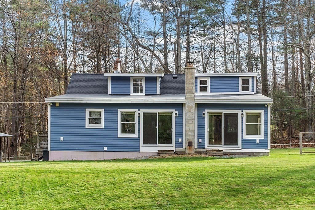 91 Gilchrest Street Lunenburg, MA 01462 - Photo 11 of 38 a view of a brick house with a large windows and a large tree