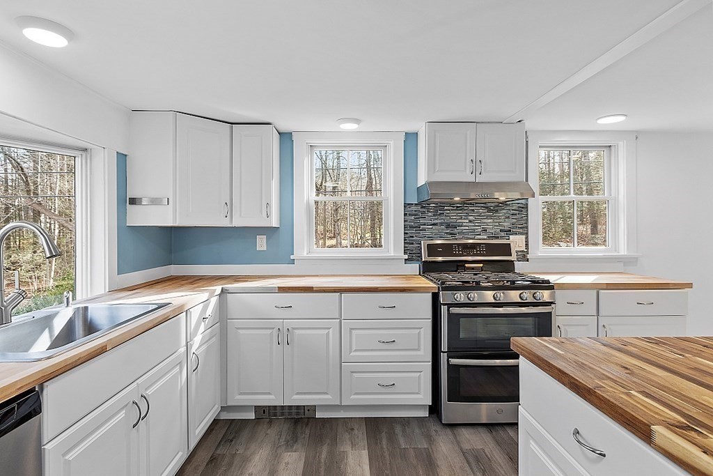 91 Gilchrest Street Lunenburg, MA 01462 - Photo 19 of 38 a kitchen with cabinets appliances a sink and a window