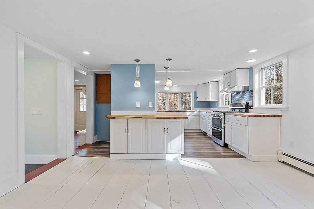 91 Gilchrest Street Lunenburg, MA 01462 - Photo 20 of 38 a large white kitchen with cabinets and a sink