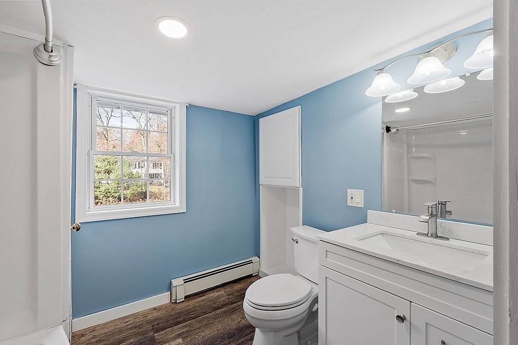 91 Gilchrest Street Lunenburg, MA 01462 - Photo 31 of 38 a bathroom with a sink a toilet and a mirror