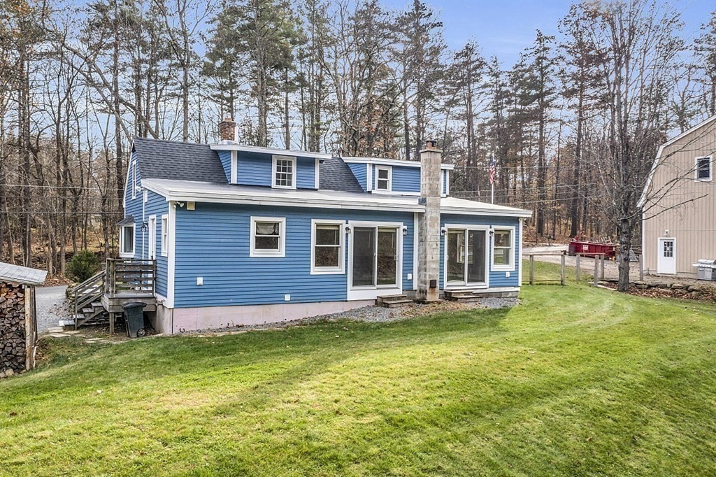 91 Gilchrest Street Lunenburg, MA 01462 - Photo 10 of 38 front view of a house with a yard table and chairs
