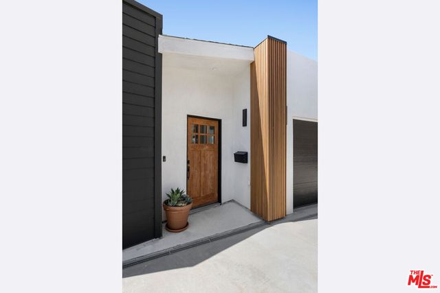 a living room with a rug and a large window