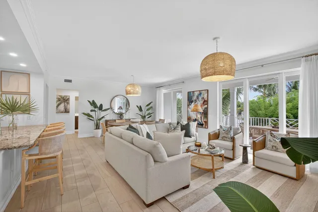 a living room with furniture chandelier and a large window